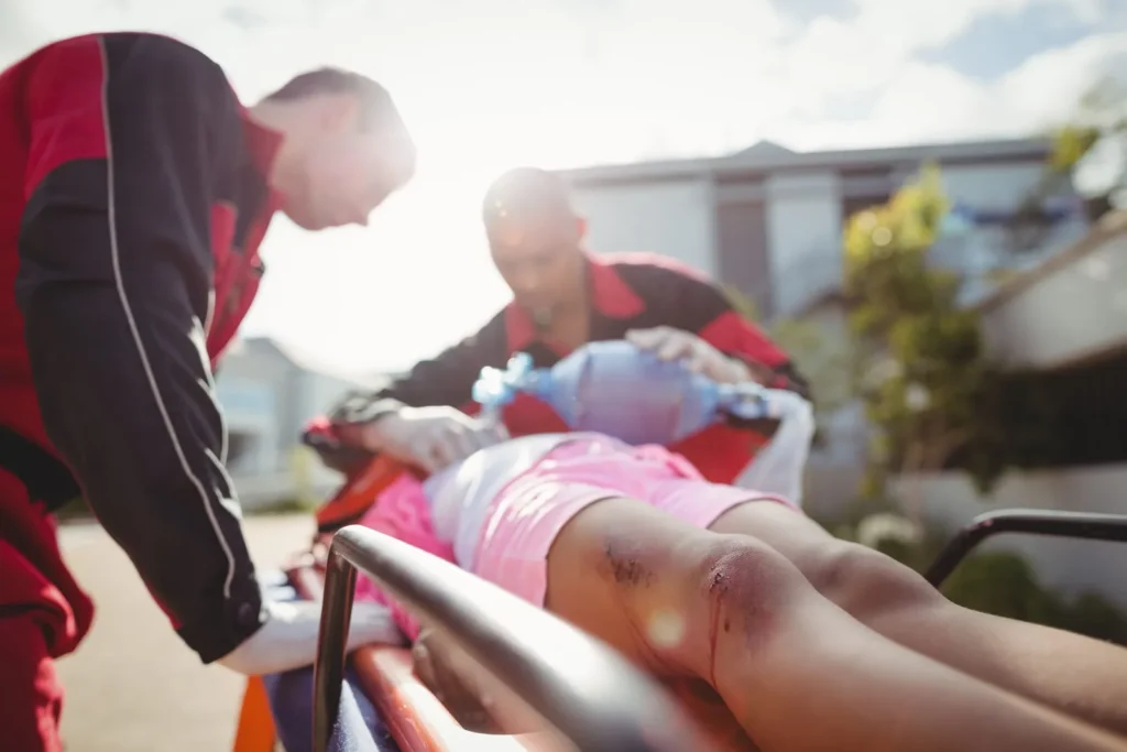 Paramedics caring for an injured person on a stretcher